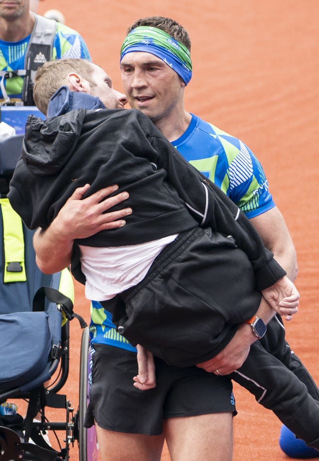 Kevin Sinfield carrying Rob Burrow over the finish line 