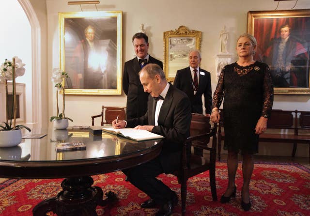 Taoiseach Micheal Martin signs the guest book as he arrives for a formal dinner at Mansion House in London