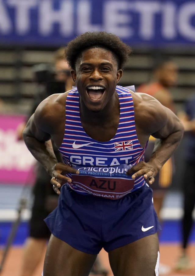 British sprinter Jeremiah Azu smiles at the camera while showing off his GB shirt