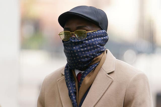 Reality TV star Emmanuel Nwanze, with a scarf covering his mouth and nose, arriving at Westminster Magistrates’ Court