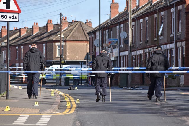 Police officers examine the scene in Chandos Street, Coventry
