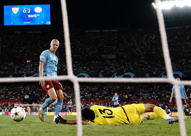 Erling Haaland, left, watches his second goal go in against Sevilla