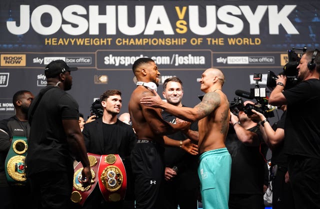 An intense stare down gave way to polite smiles between Anthony Joshua and Oleksandr Usyk at Friday's weigh-in (Zac Goodwin/PA)