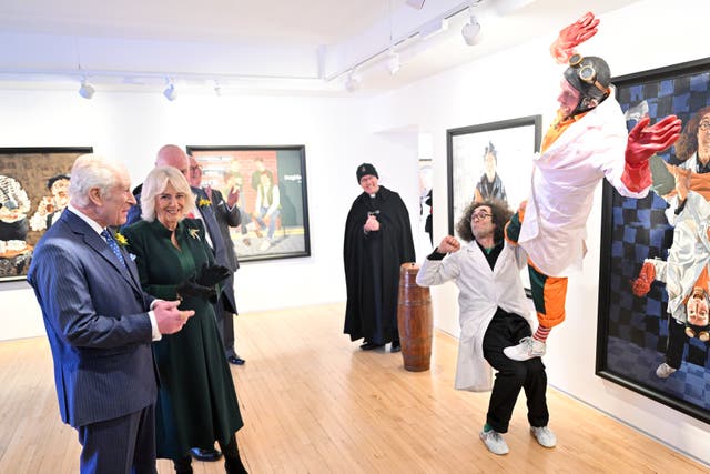 Charles and Camilla watch a trick being performed