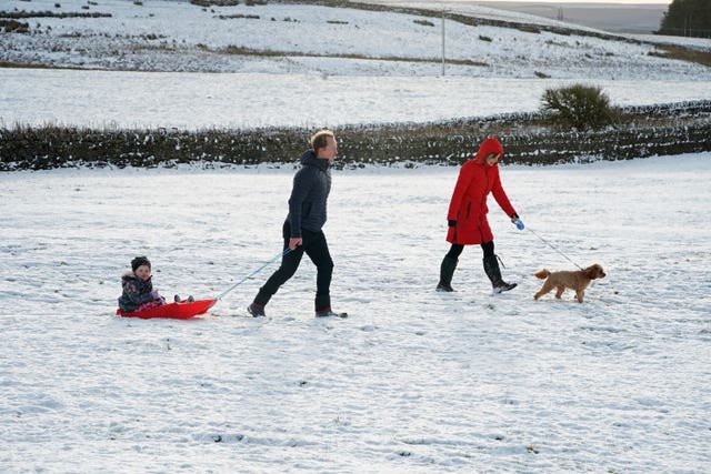 A family take advantage of the Christmas Day snow with a trip out sledging on the hills