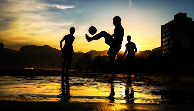 Children play football on Ipanema Beach in Rio de Janeiro during the 2014 World Cup. Hosts Brazil would suffer a humiliating 7-1 semi-final defeat to eventual winners Germany, while winless England failed to progress from the group stage of the tournament under Roy Hodgson