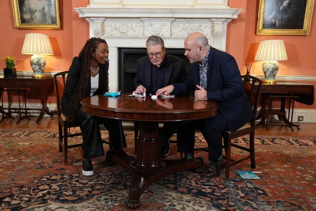 From left, Sir Keir, ambassador Beverley Knight and Richard Angell, chief executive of the Terrence Higgins Trust, check the results