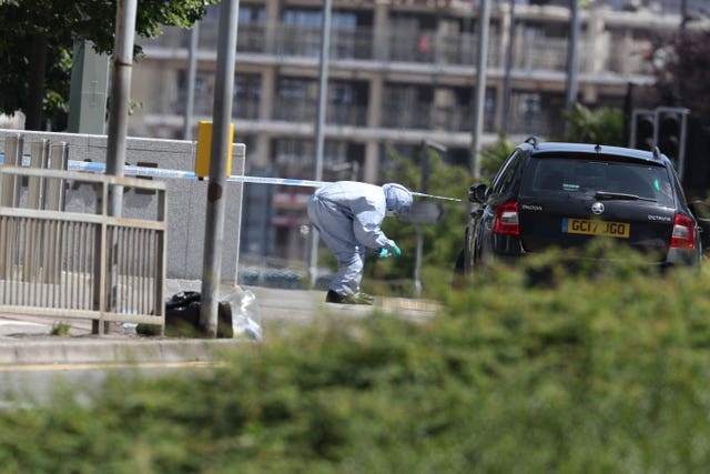 Police forensics officers at work near Forbury Gardens in Reading