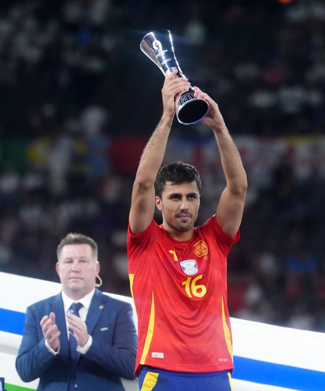 Spain’s Rodri is awarded the Player of the Tournament trophy after the 2-1 Euro 2024 final victory over England