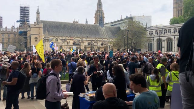 People take part in an anti-vaccine protest in Parliament Square 