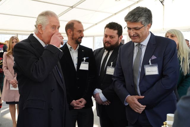 Charles takes a sip of Syrian tea