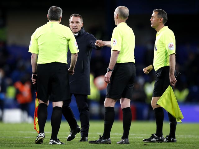 Brendan Rodgers, second left, speaks to the match officials after the game