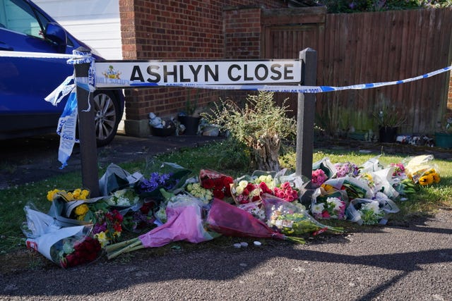 Floral tributes near to the scene in Ashlyn Close, Bushey, Hertfordshire, where Carol Hunt, the wife of BBC racing commentator John Hunt, and two of their daughters, Hannah and Louise, were killed in a crossbow attack at their home