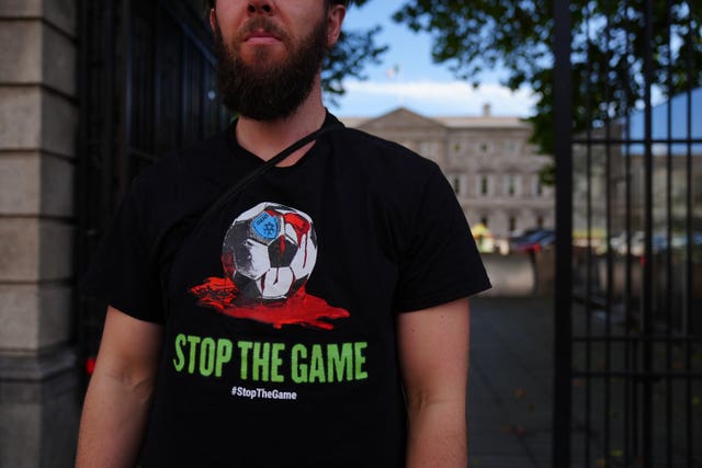 A man wearing a “Stop the Game” T-shirt