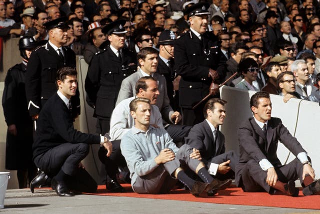 Norman Hunter looks on along with other non-playing reserves during the 1966 World Cup final at Wembley