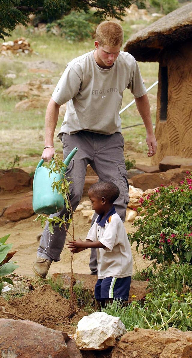 Harry and four-year-old Mutsu Potsane planting a peach tree in Lesotho in 2004