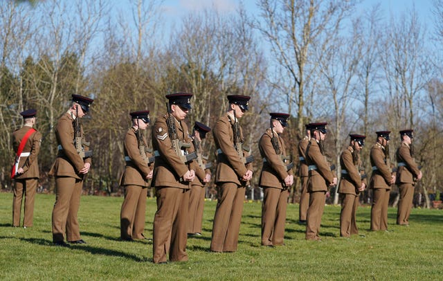 Members of the Armed Forces pay respects at the funeral