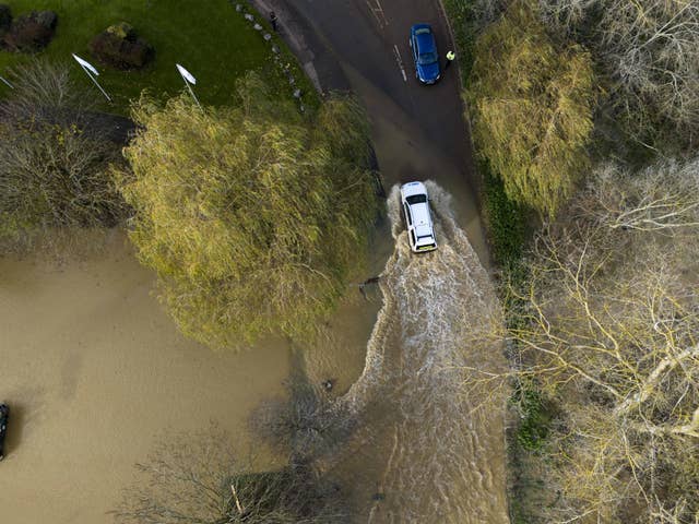 A car driving on a flooded road