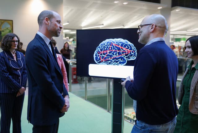 William speaks to researchers who study how the brain works during a visit to the Francis Crick Institute 