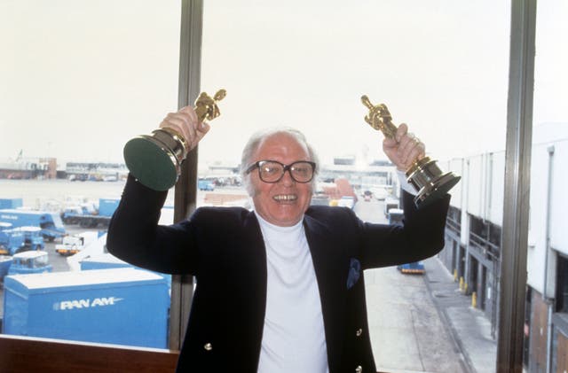 Sir Richard Attenborough arrives at Heathrow Airport with the Oscars he won for his film Gandhi (PA)