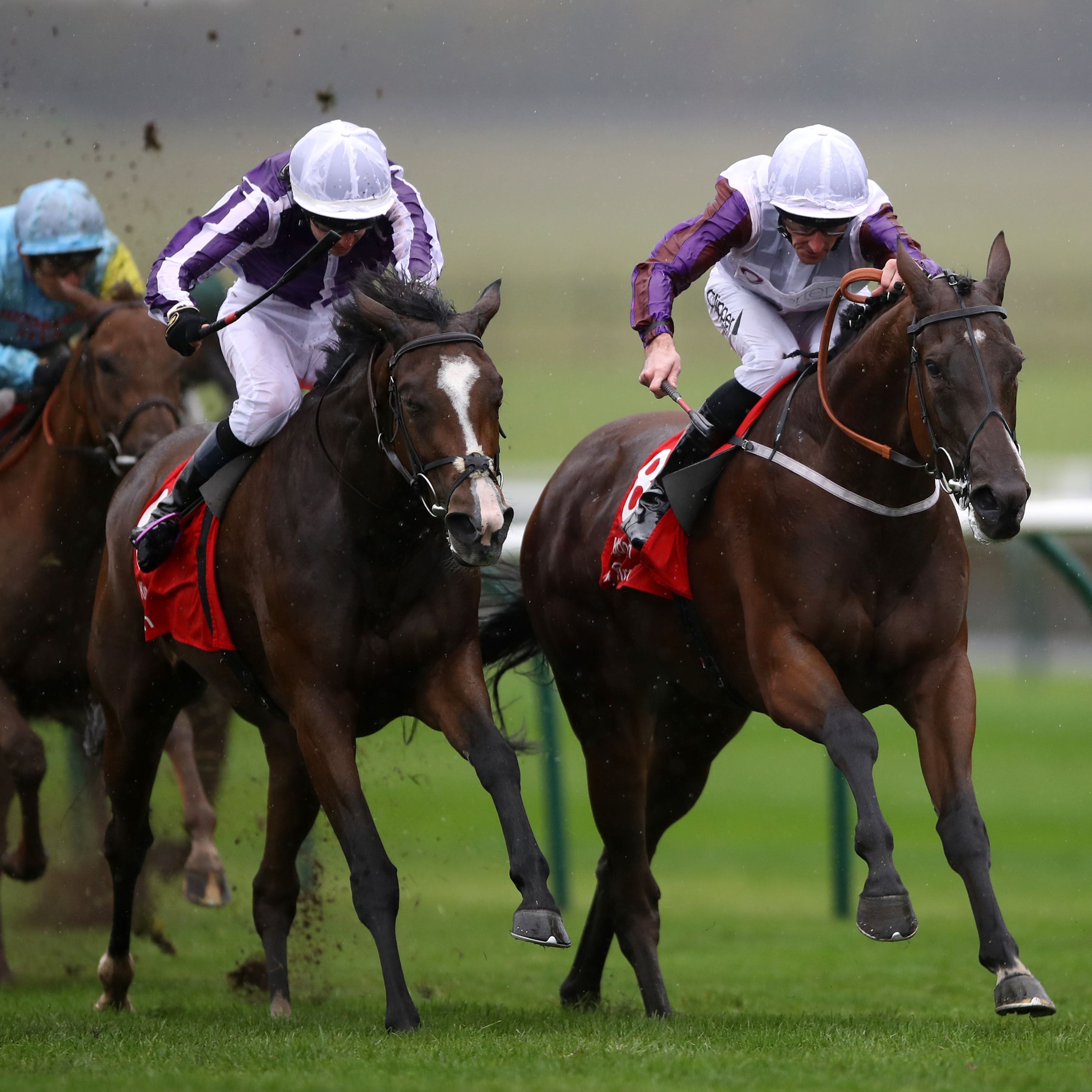 Laurens (right) holds on in the Sun Chariot at Newmarket
