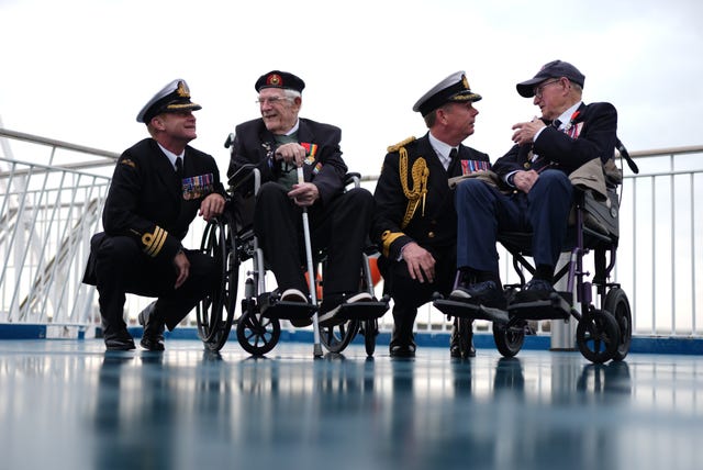 From left, Royal Navy Commander Glen Hinson, D-Day veteran Jim Grant, Royal Navy Commodore John Boyce, and D-Day veteran Charles Horne