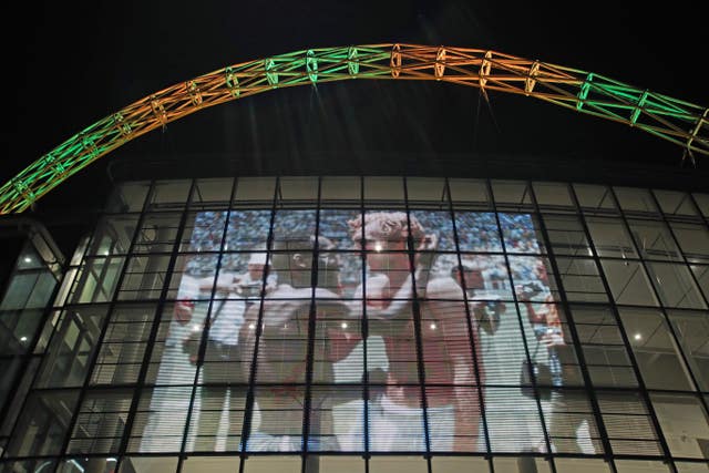 Wembley Stadium’s arch is lit up in the colours of Brazil following the death of Pele