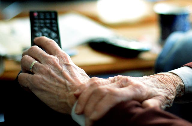 An older person watching TV 