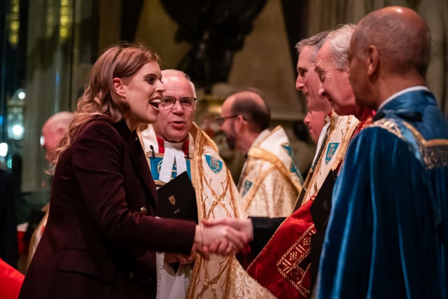 Princess Beatrice shakes hands with one of the ministers 