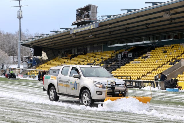 Snow is cleared from the pitch prior to the cinch Premiership match between Livingston and Rangers at the Tony Macaroni Arena