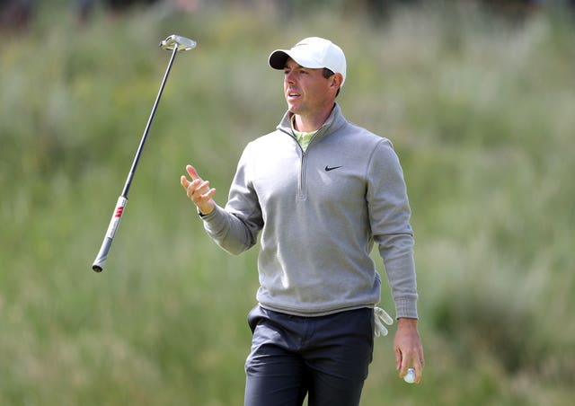 Rory McIlroy juggles his putter