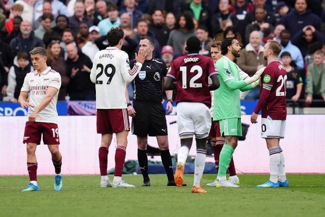 West Ham and Arsenal players surround the referee