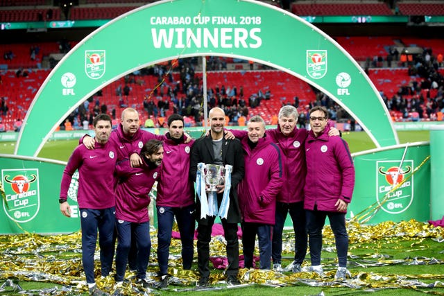 Pep Guardiola and his coaching staff pose with the Carabao Cup last season