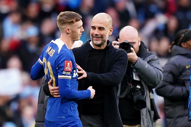 Manchester City manager Pep Guardiola embraces Chelsea’s Cole Palmer, left, following the Emirates FA Cup semi-final