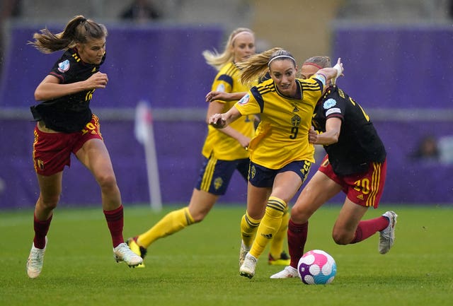 Kosovare Asllani, centre, is pulled back by Belgium's Julie Biesmans