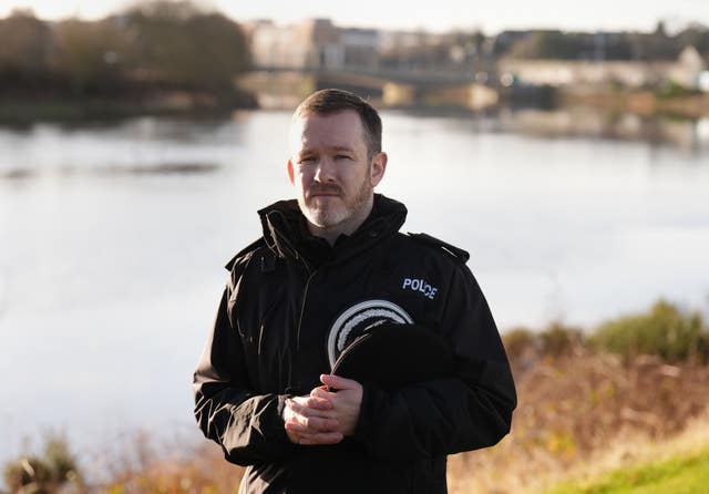 Superintendent David Howieson with police hat under arm standing in front of river Dee in Aberdeen