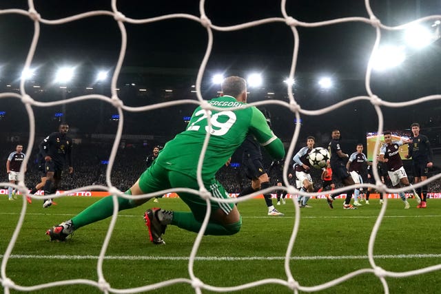 Ollie Watkins attempts a shot on goal which is saved by Juventus goalkeeper Michele Di Gregorio