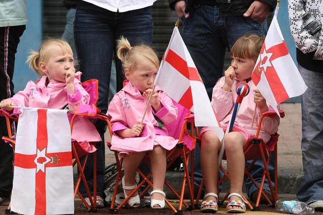 Young girls watch the celebrations in ventral Belfast as the Orange Order and marching bands mark the Battle of the Boyne