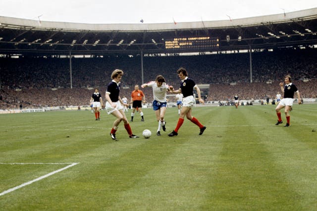 Gordon McQueen tackles an England player during a match at Wembley