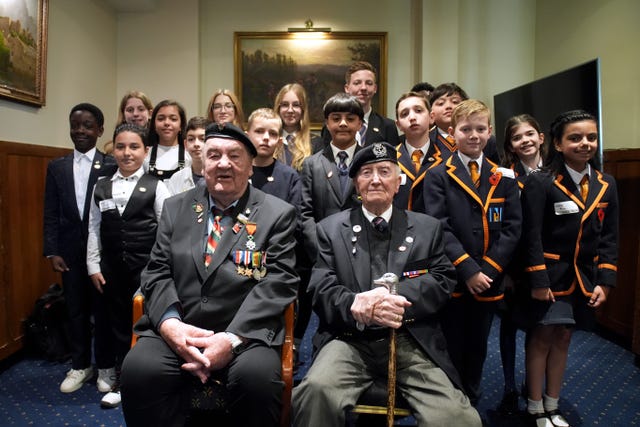 D-Day veterans Richard Aldred (left), 99, and Stan Ford, 98, meeting school children at the Union Jack Club in London