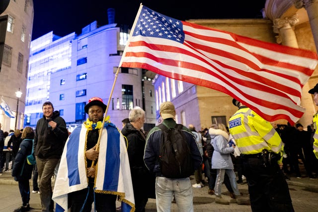 A man holding the US flag during a protest outside the BBC’s Broadcasting House in central London 