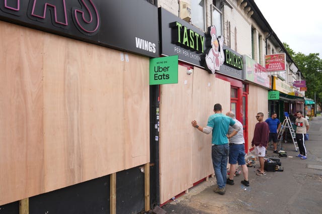 Small business owners boarding up at shops in Northampton ahead of an anticipated anti-immigration protest