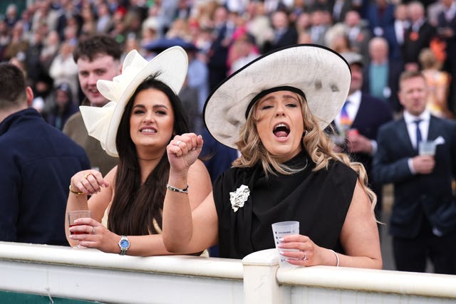 Racegoers react during the William Hill Handicap Chase on Grand National Day of the Randox Grand National Festival 2026 at Aintree Racecourse