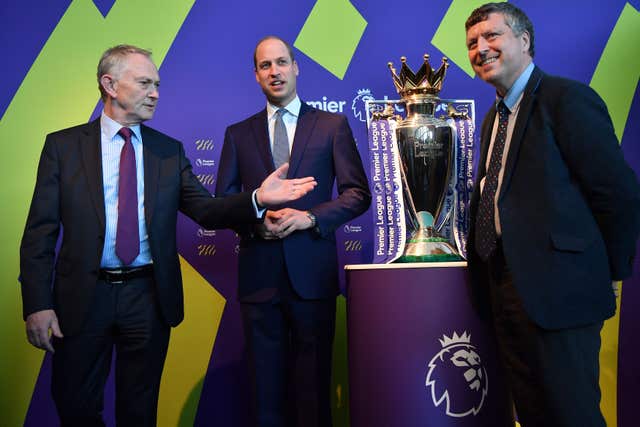The Duke of Cambridge (centre) standing next to the Premier League football trophy (Ben Stansall/PA)
