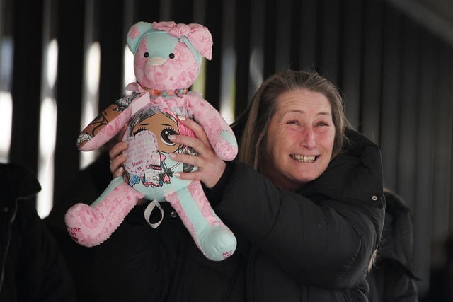 Cheryl Korbel, mother of nine-year-old Olivia, holding a teddy bear outside Manchester Crown Court 