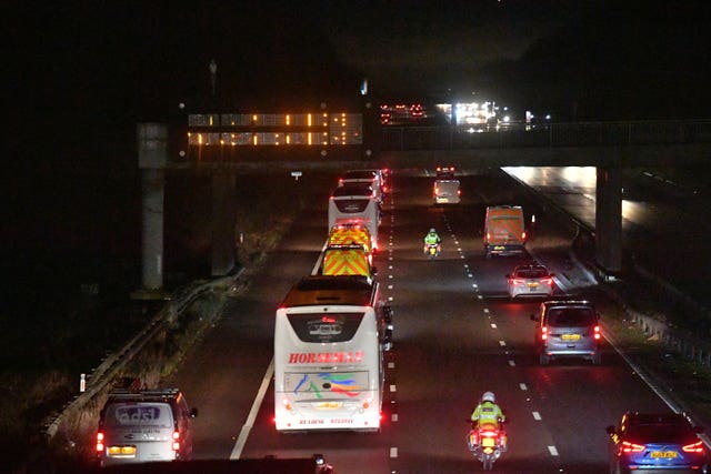 The convoy of buses heads along the M6 motorway on their way to Arrowe Park Hospital in Merseyside