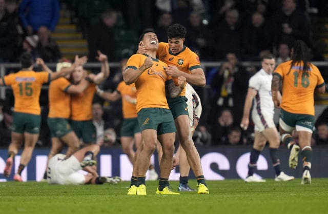 Australia celebrate scoring a try against England