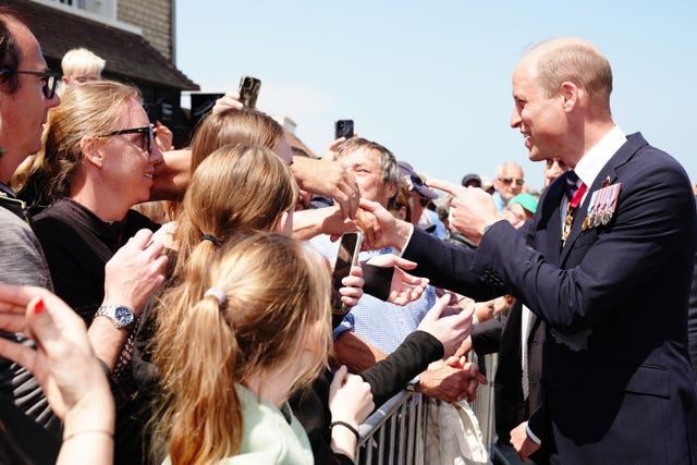 The Prince of Wales meeting veterans and members of the public during his visit to Arromanches