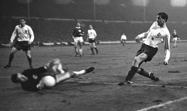West Germany goalkeeper Hans Tilkowski denies Hunter during an international friendly in February 1966