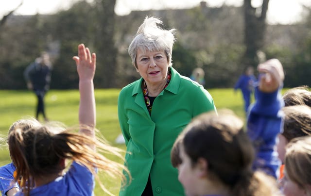Former prime minister Theresa May talks to schoolgirls at a football session during a visit to St Mary’s Catholic Primary School in Maidenhead, Berkshire